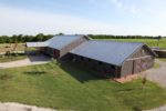 A Complete Metal Building Home with a Pool and a Stable