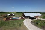 A Complete Metal Building Home with a Pool and a Stable